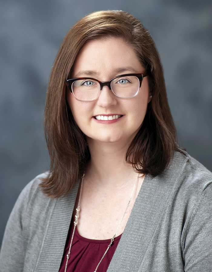 Formal studio headshot portrait of Heather Rowe